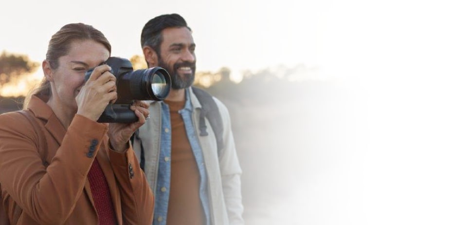 A couple on safari with a camera