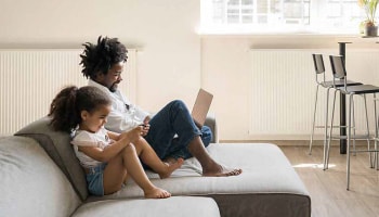 Father and daughter on couch