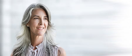 old woman with long hair smiling 