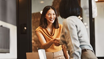 Two women shaking hands